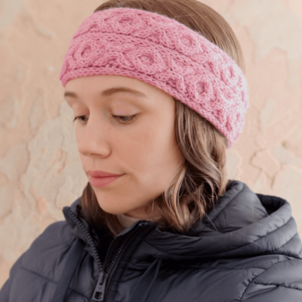 A side view of a knit headband featuring X and O cables