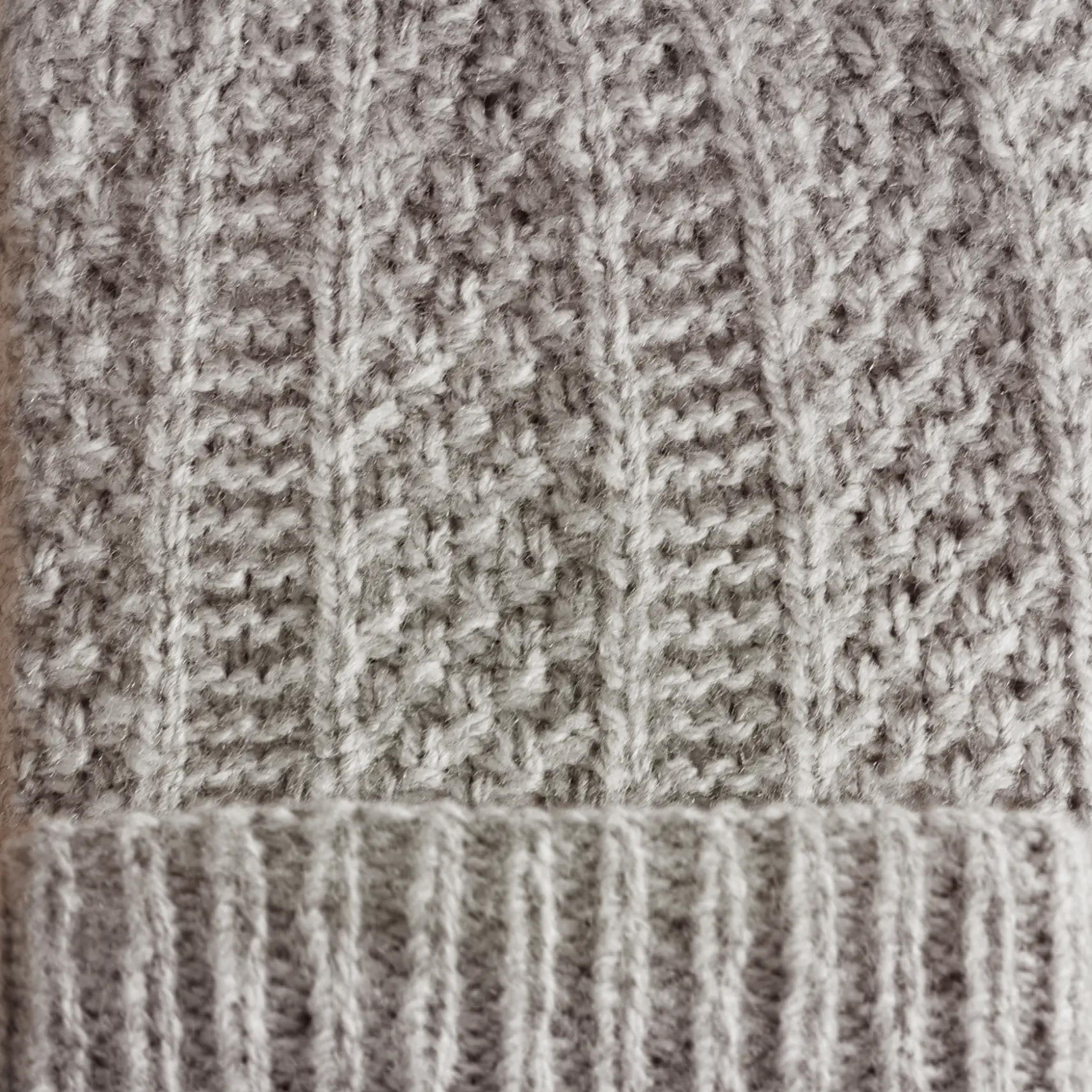 Close up of cambronne beanie stitches including garter, ribbing, and double seed stitch