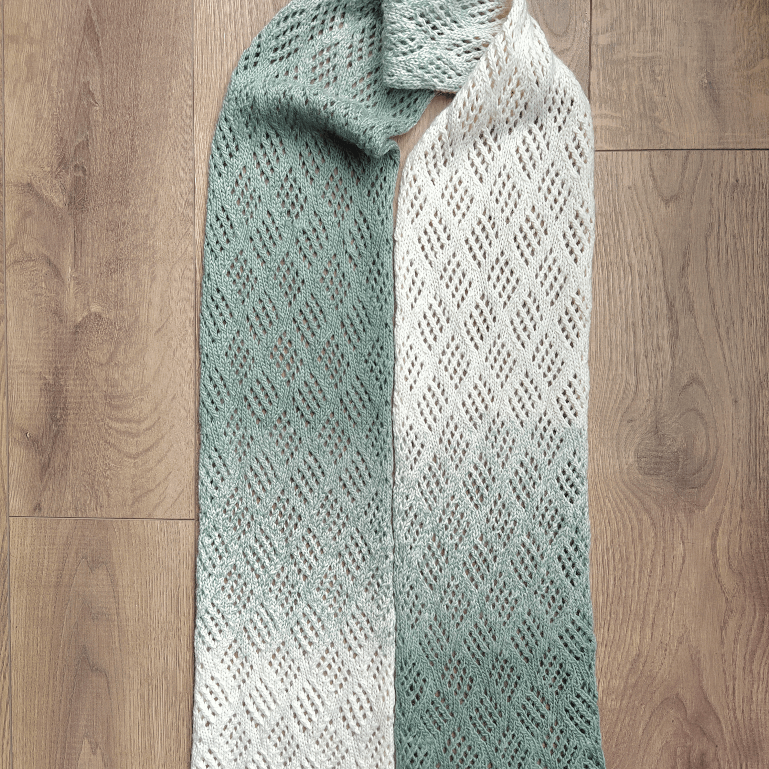 Flatlay of Checkerboard lace scarf by Purl Soho. Knit by Knitq.