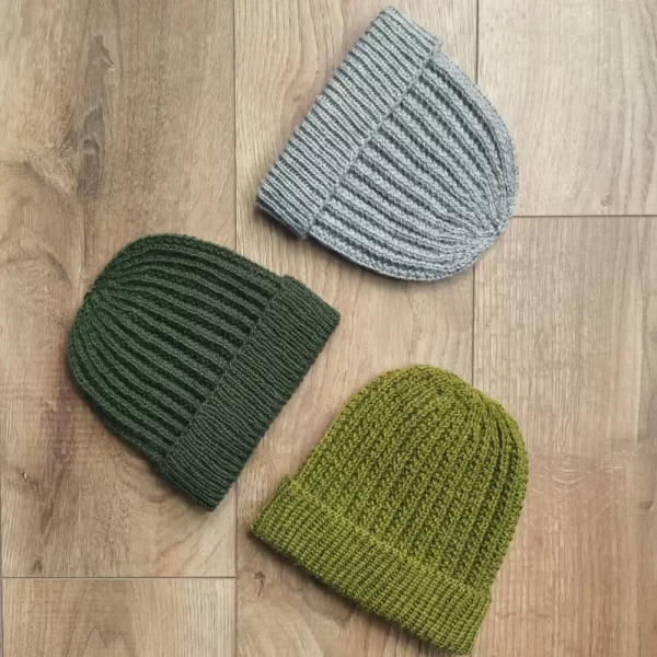 three hats lying against a wood backdrop