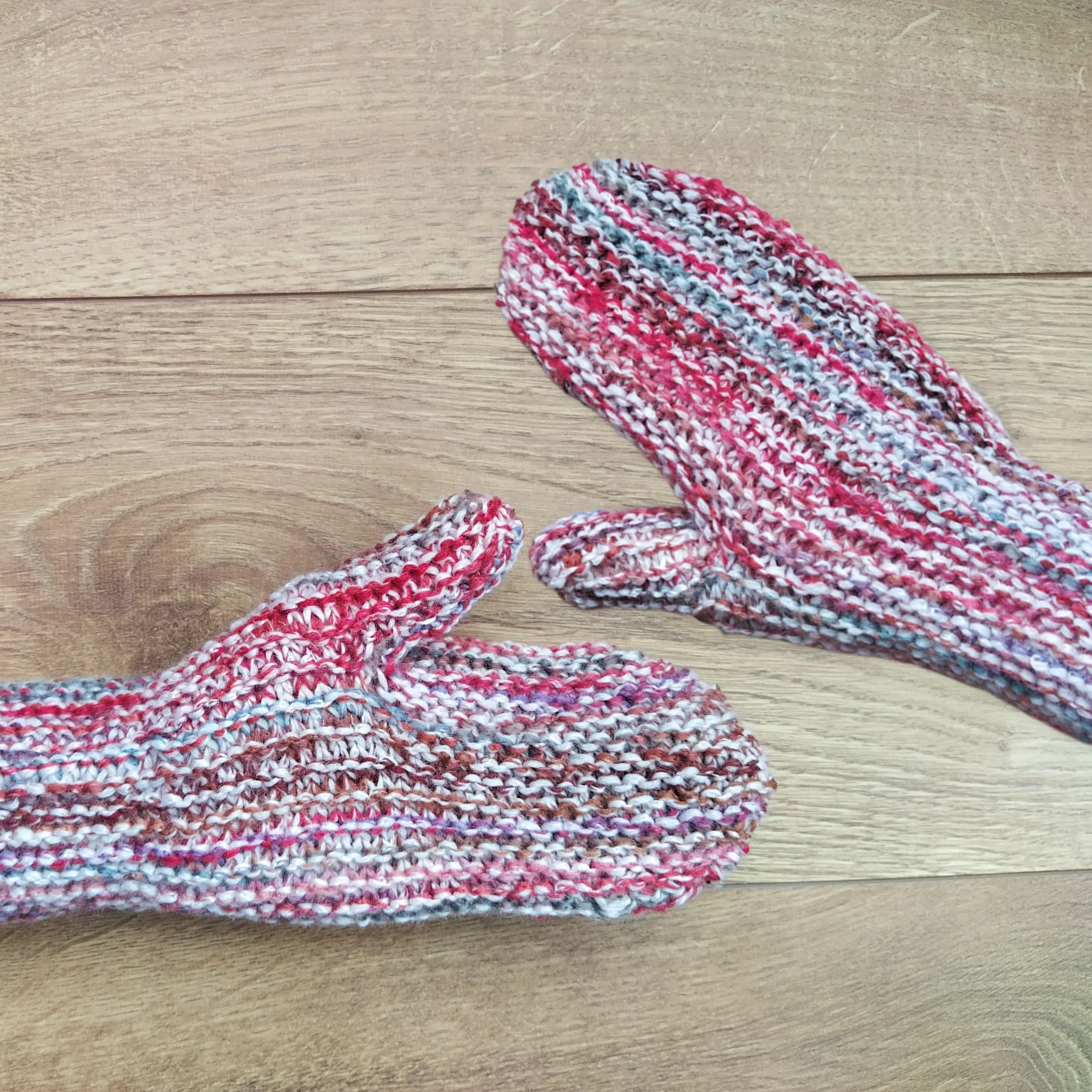 Sideways knit mittens being worn