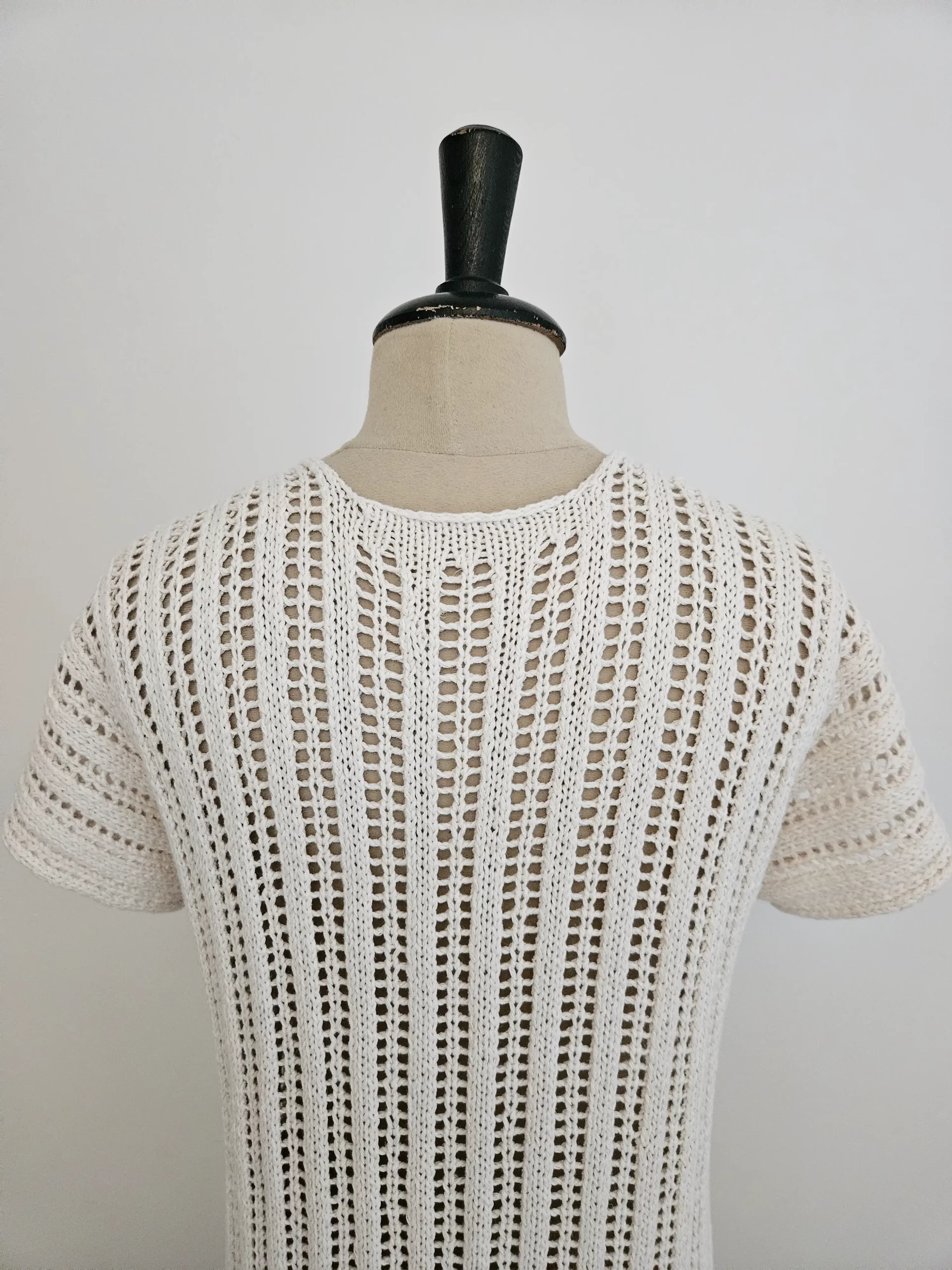 A close up of the Reya Swimsuit cover up on a mannequin showing the texture of the ladder lace stitch