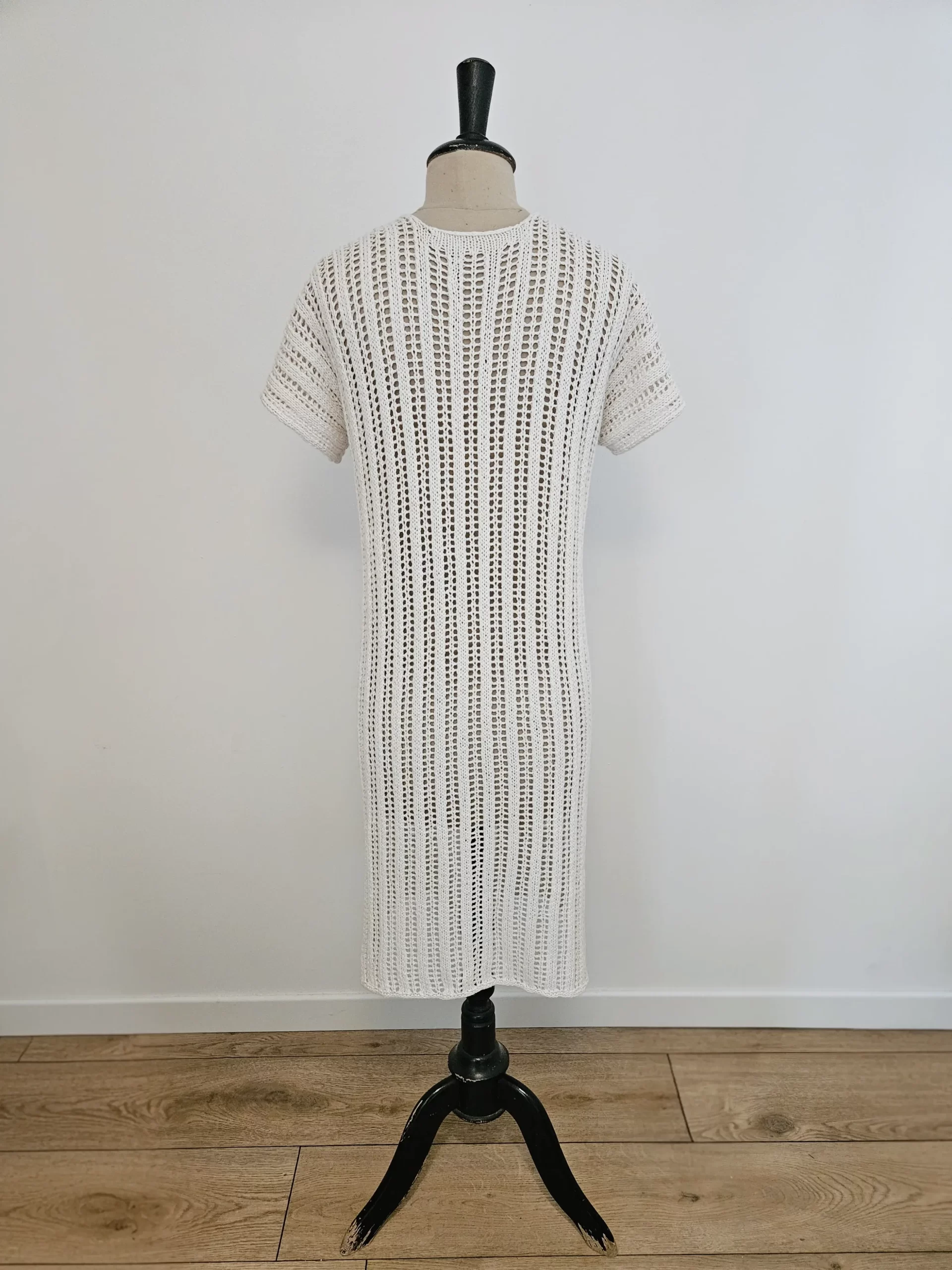 The reya swuimsuit cover up from the back being displayed on a mannequin